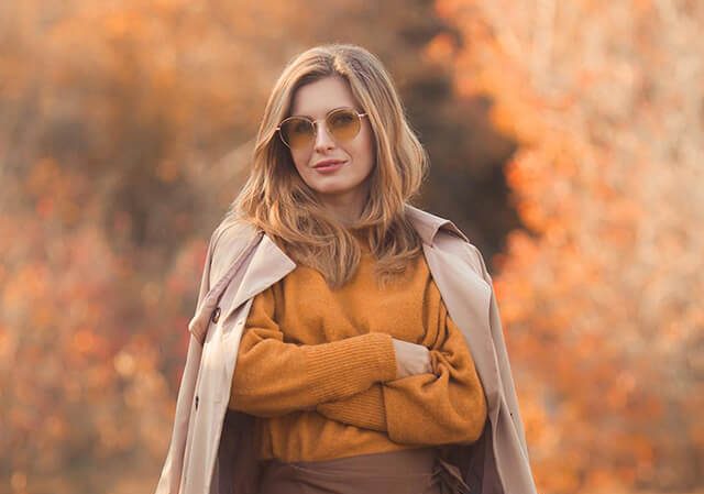 portrait-woman-standing-with-autumn-leaves_1048944-108918381-1